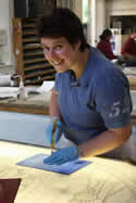 Laura is cutting glass for her new commission.